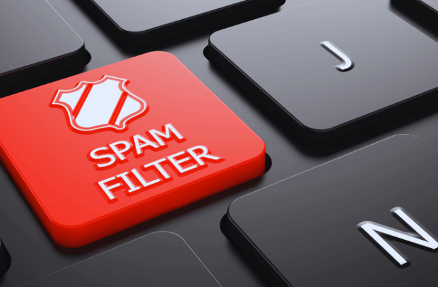 Red spam filter key on a black keyboard