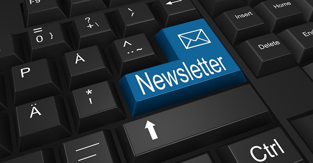 Computer keyboard with a blue newsletter button
