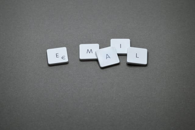 Letter tiles on a dark surface spelling the word EMAIL