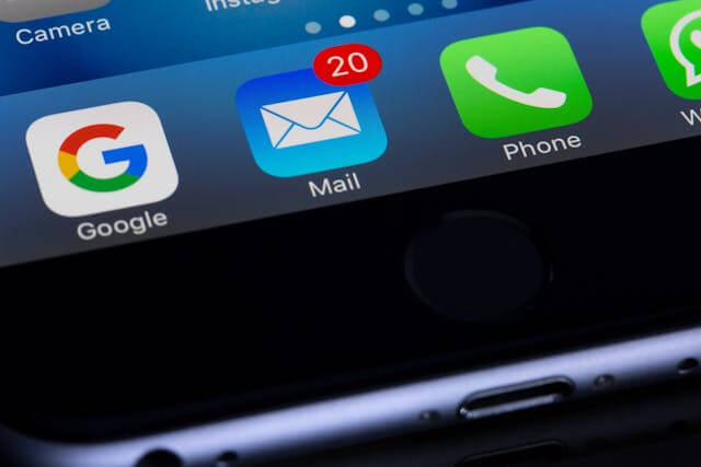 Close-up of smartphone showing unread email notifications
