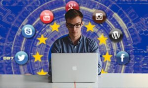 Person at laptop surrounded by social media and search platform icons with stars in the background