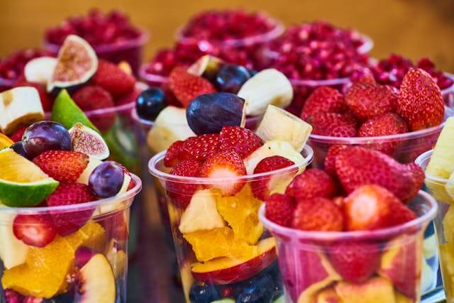Colorful fruit cups arranged in clear plastic containers representing creative ad concepts