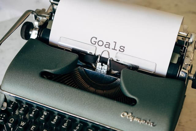 Vintage typewriter with a sheet of paper reading “Goals”