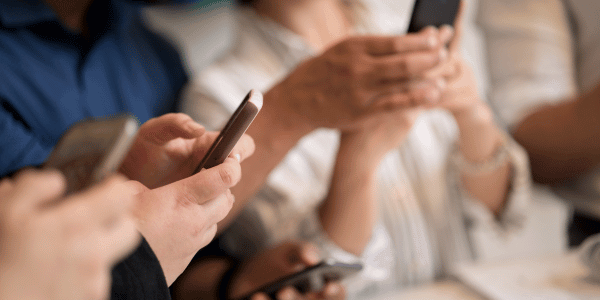 Boutique owner in Denton recording Instagram Reel showing new product arrivals