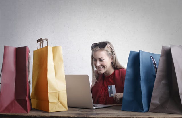 Customer browsing online with colorful shopping bags, representing an easy digital experience.