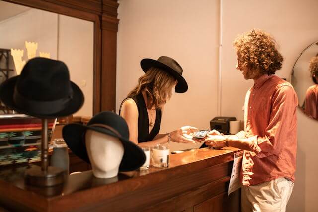 Two people talking in a shop, representing local businesses connecting with customers through Facebook Groups