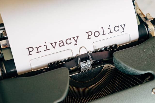 Typewriter with the words privacy policy representing privacy laws and business compliance