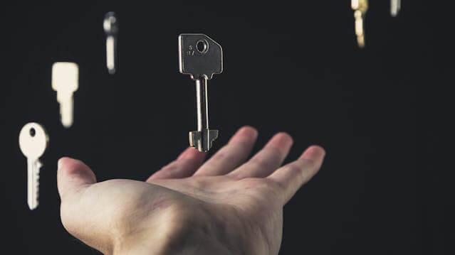 Hand holding floating keys to represent protecting customer data in digital marketing