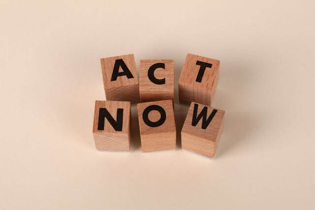 Wooden letter blocks spelling Act Now, representing a Facebook Groups call to action for local business marketing
