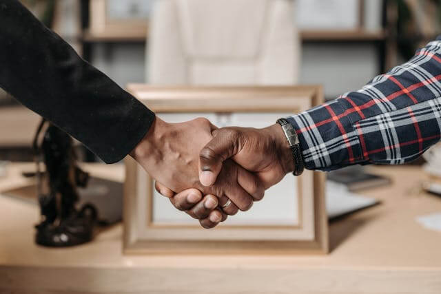 Two people shaking hands to represent trust-based digital marketing for small businesses