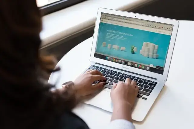 Small business owner updating company information on a website